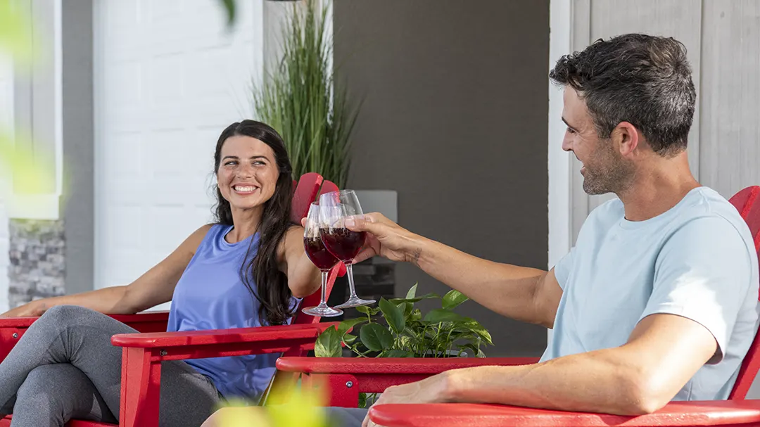 Husband and wife sitting together on front porch